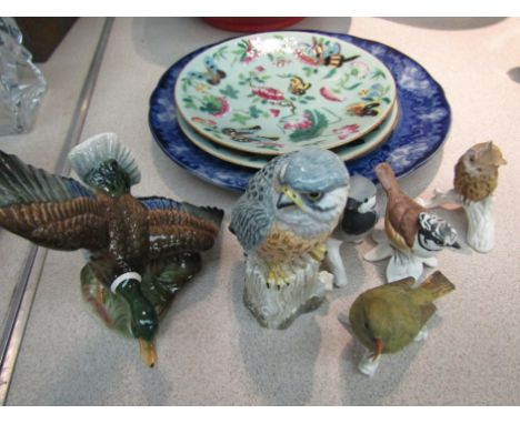 a collection of ceramic birds including Goebel and Mack together with two celadon plates decorated with butterflies and flowe