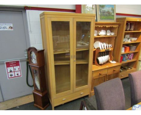 A modern light oak full height glazed bookcase with single drawer to base, 196cm x 100cm 