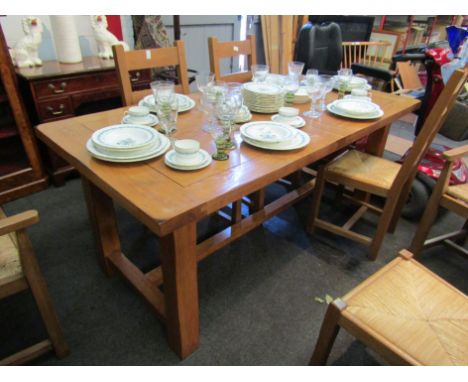 A modern oak extending dining table and a set of six (4+2) ladder back rush seated chairs