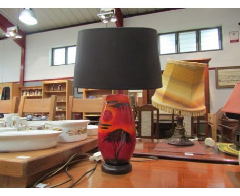 A Poole Pottery table lamp base, red sunset design with shade
