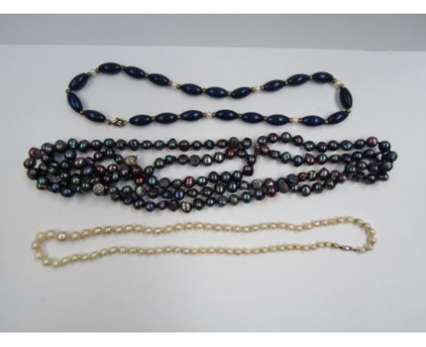 A graduated pearl single strand necklace together with a three strand black/blue pearl necklace and a lapis lazuli and pearl 