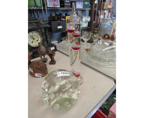 A large clear Art Glass bubble paperweight and a Gallileo thermometer 