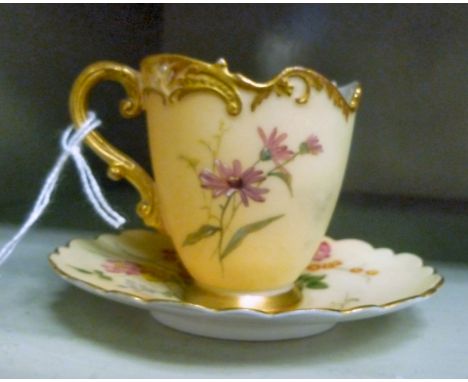 An early 20thC Royal Worcester blush ivory glazed porcelain miniature cup and saucer, decorated with flora  bears a date cyph