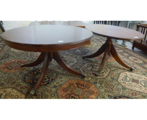 Two modern mahogany finished pedestal tables, each having a turned column, raised on a tripod base  20''h  36''w             