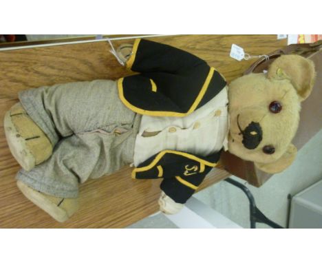 A 20thC Chad Valley Teddy bear, having mobile limbs, bears a button to the ear; and various accessories, in a snakeskin effec