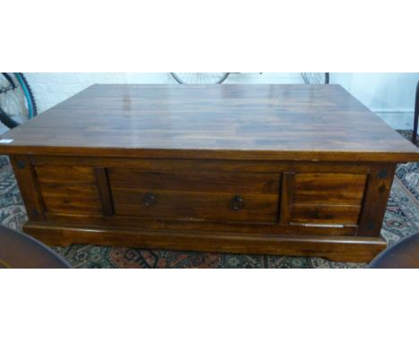 A modern stained hardwood, box design coffee table, having a blocked top, over a long drawer, raised on a bracket plinth  16'