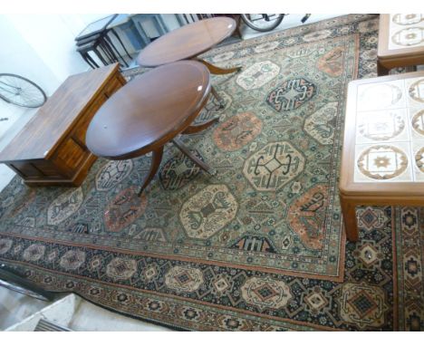 A 20thC BMK woollen carpet with stylised octagonal motifs, bordered by foliage on a blue ground  108'' x 142''       BSR