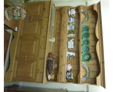 A modern waxed pine farmhouse dresser, having a tongued and grooved planked back superstructure with two open shelves and fiv