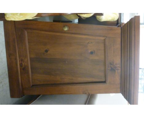 A pair of modern mahogany finished pedestal cupboards, each having a shelf top, over tapered sides and a full height door, on