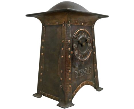 An Arts &amp; Crafts copper mantle clock, circa 1905, unsigned, the dial with Roman numerals, the lower section inverted, ove