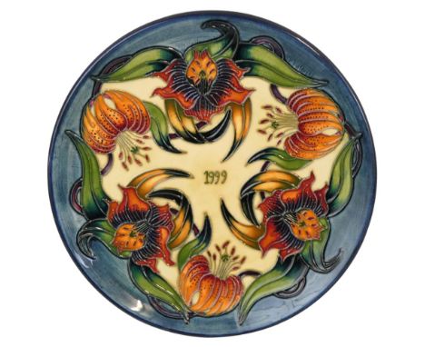 A Moorcroft pottery Annual Year plate '1999' decorated with the 'Tiger Lily' pattern, limited edition, copyright 1998, 'Pitch