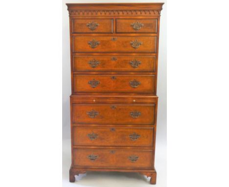 A walnut and burr walnut chest on chest, the moulded frieze over two short drawers over three long drawers, pull out slide ov
