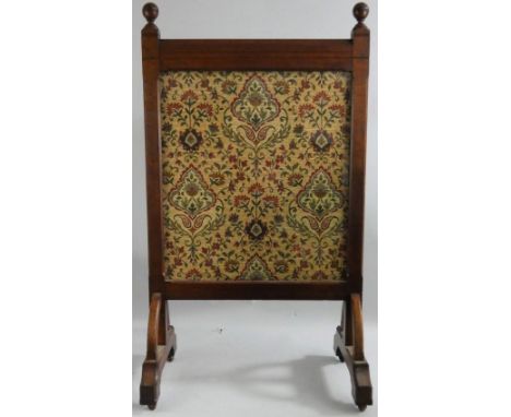 A late Victorian oak glazed fire screen, the front opening to reveal a tapestry panel, glazed obverse panel, raised on an arc