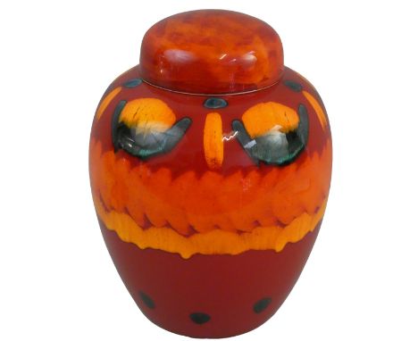 A large Poole Pottery lidded ginger jar in the 'Volcano' pattern, with green yellow glaze on a red ground, embossed factory m