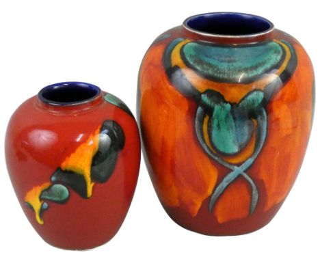 Two Poole Pottery vases of baluster form, one decorated with green yellow glaze on a red ground, moulded factory marks, heigh