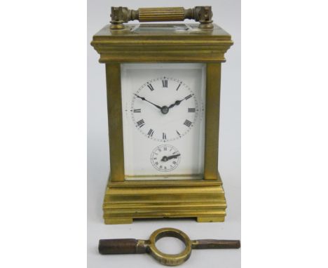 An early 20th century brass miniature alarm/carriage clock, the white enamel dial with Roman numerals and two dials, the move