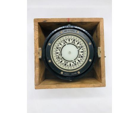 A ships compass in a wooden box 