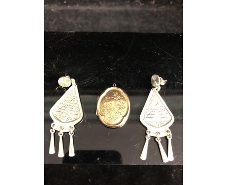 A 9ct yellow gold locket, quatrefoild shape, engraved with birds in branches, stamped 9ct Front/Back; and two 925 Sterling ma