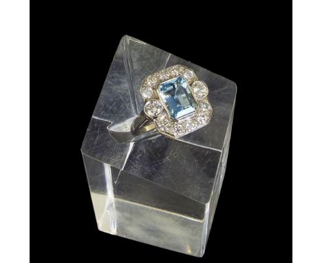 Fine 18ct white gold aquamarine and diamond cluster ring, the emerald-cut aquamarine within a surround of round-brilliant-cut