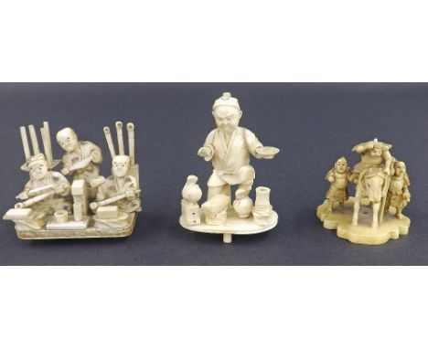 Japanese carved sectional okimono depicting a street vendor, signed, 3.25" high; together with another okimono depicting thre