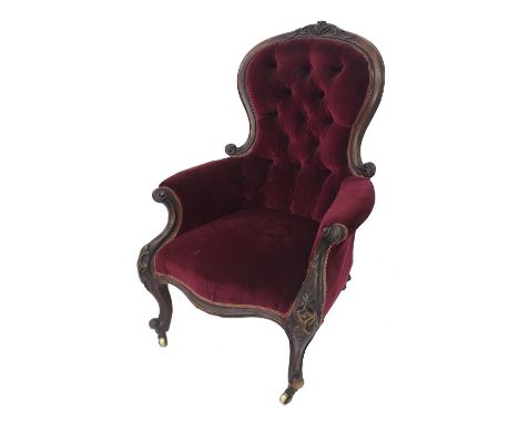 Victorian mahogany button-back salon chair, with acanthus carvings and cabriole front legs with brass castors, 43" high