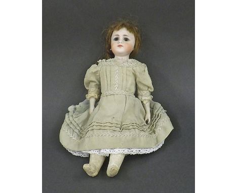 Bisque headed leather bodied doll, with fixed jewelled eyes, pearl earrings, antique dress and bisque hands, possibly by Simo