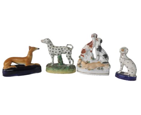 Four various Staffordshire figures of hounds, including a greyhound spill vase and a hunting group (4)