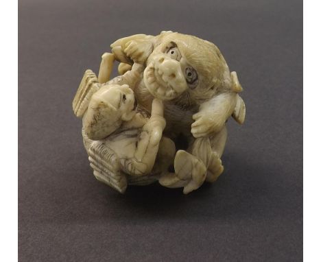 Japanese ivory netsuke depicting a huntsman and mystical bear, 2" high