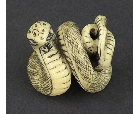 Japanese stained ivory netsuke as a coiled snake, signed, 1.25" high