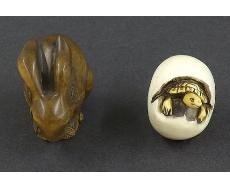 Japanese ivory netsuke of a turtle in an egg, 1.5" long; also a carved netsuke of a rabbit, 1.5" high (2)