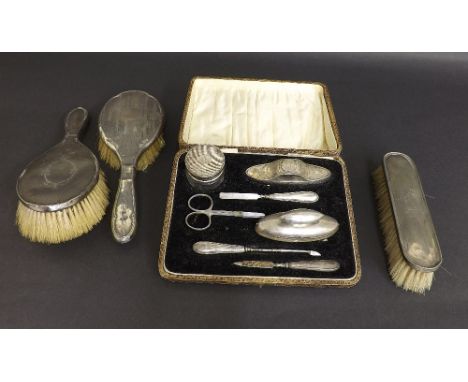 Vintage cased silver vanity set with manicure items etc; together with three silver dressing brushes