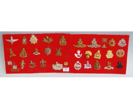 A collection of assorted cap badges and insignia, to include Royal Artillery, Royal Army Ordnance Corps, Duke of Lancaster's 
