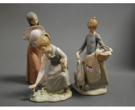 A Lladro porcelain figure of a girl feeding geese, printed mark verso, impressed I27, height 25cm, together with a Lladro fig