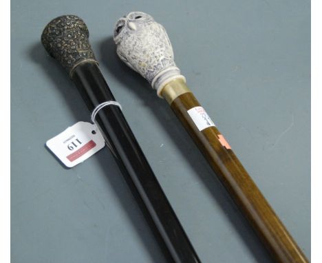 A late Victorian walking stick, having ebony shaft and embossed silver handle; together with one other modern walking stick (