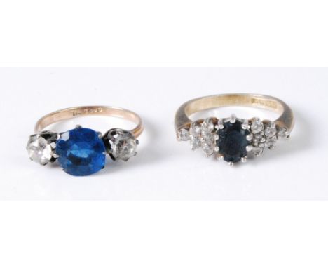 A 9ct gold, faux sapphire and cz set three stone dress ring; together with a silver gilt, sapphire and paste ring (2)