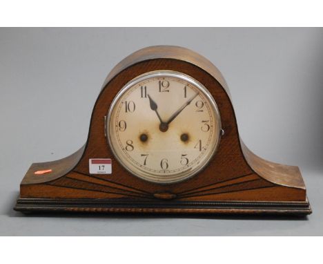 A 1930s oak cased mantel clock having a silvered dial with Arabic numerals and eight day movement, striking on a gong