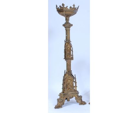 A large cast brass alter stick, in the 17th century Baroque style, the triform column set with Biblical figures within arched