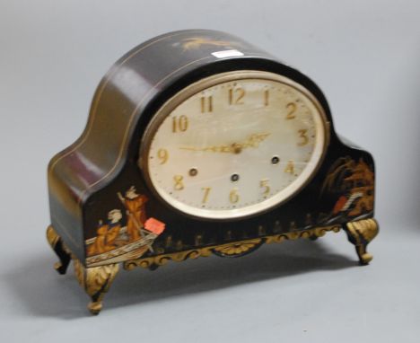 A 1920s chinoiserie decorated mantel clock, having an oval silvered dial with Arabic numerals and chiming movement, the case 