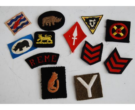 A collection of cloth formation signs, to include 7th Armoured Division, First Army Corps, and Royal Electrical Mechanical En