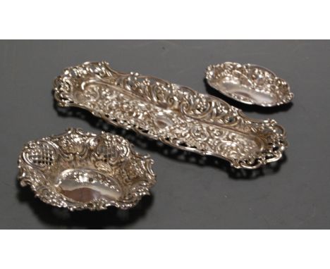 A late Victorian silver bonbon dish of pierced oval form having repoussee floral and C-scroll decoration, maker Henry Matthew