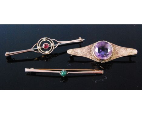 A circa 1920 9ct gold ruby and seed pearl set bar brooch, 5.5cm, together with a green hard stone set safety pin bar brooch i