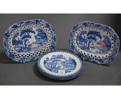 A pair of 19th century blue and white plates, each of oval form, the central panel transfer decorated in the Chinese taste wi