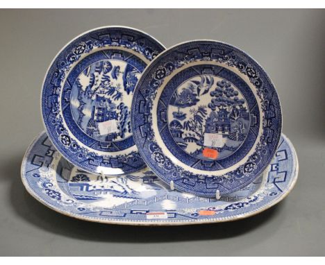 A large Victorian ironstone blue and white meat plate transfer decorated in the Chinese taste, together with a pair of simila
