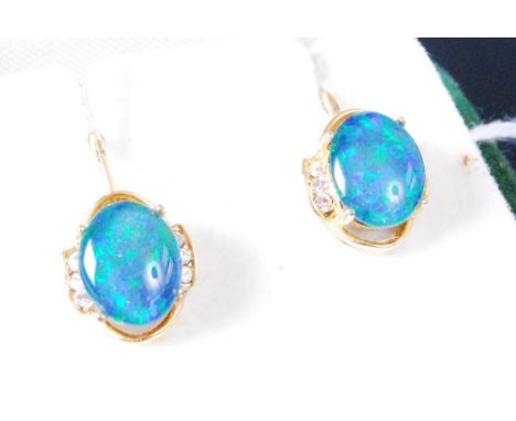 A pair of yellow metal, opal and cz set ear clips, the opal doublets being four claw set, each with sprung screw backs, 12mm 