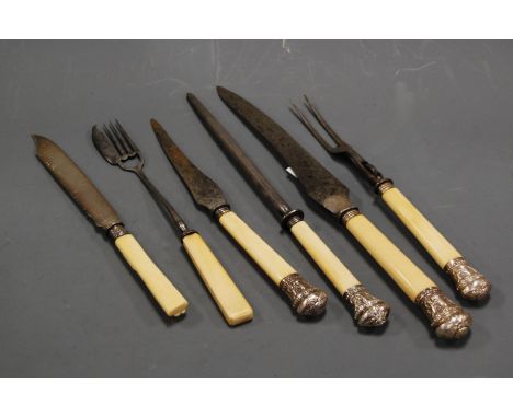 An early 20th century four-piece carving set, each piece having steel blade/fork, with ivory handles and embossed silver moun