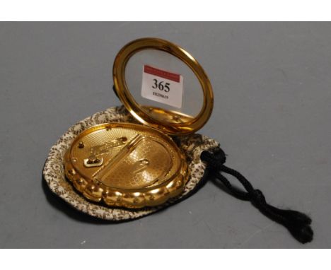 A ladies Kigu "Minuette" gilt metal powder compact with foliate C-scroll decoration in pouch