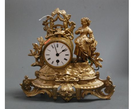 A late 19th century French gilt metal mantel clock having a circular dial with Roman numerals and cylinder movement, the whol