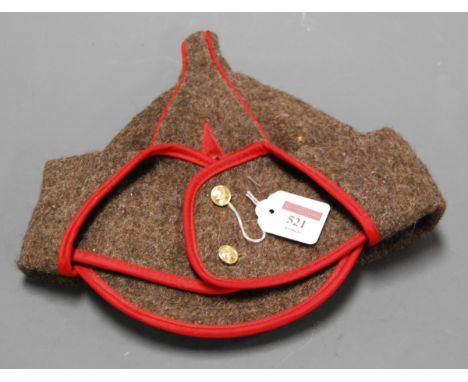 A Soviet Red Army Budenovka having stitched red star with enamel badge and folding side flaps