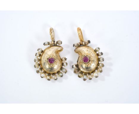 Pair Indian gold, ruby and seed pearl earrings of bombé boteh form, each set with a central round mixed cut ruby and a border