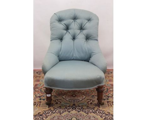 Victorian low button back chair, powder blue upholstery raised on bead moulded fluted legs and brass castors, castors stamped